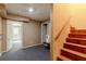 Finished basement offers flex space with carpet flooring, access to the backyard, and wooden stairs at 110 Amsterdam Dr, Lilburn, GA 30047