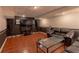 Entertainment space in finished basement with tile flooring, large sofa, and large screen TV at 110 Amsterdam Dr, Lilburn, GA 30047