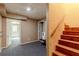 Finished basement offers flex space with carpet flooring, access to the backyard, and wooden stairs at 110 Amsterdam Dr, Lilburn, GA 30047