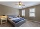 Bright bedroom with a bed, carpet, and shuttered windows allowing for natural light at 110 Amsterdam Dr, Lilburn, GA 30047