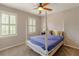 Bedroom with a four-poster bed, carpet, and shuttered windows allowing for natural light at 110 Amsterdam Dr, Lilburn, GA 30047