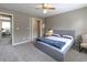 Comfortable bedroom with neutral walls, carpet, and a view to an office area at 110 Amsterdam Dr, Lilburn, GA 30047