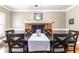 Elegant dining room featuring a brick fireplace and a large table set for a meal at 110 Amsterdam Dr, Lilburn, GA 30047