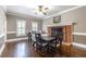 Formal dining room with a brick fireplace, hardwood floors, and a decorative ceiling fan at 110 Amsterdam Dr, Lilburn, GA 30047