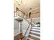 Grand foyer featuring hardwood floors, staircase with wood railings, and a chandelier at 110 Amsterdam Dr, Lilburn, GA 30047