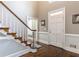 Elegant foyer with hardwood floors, white wainscoting, and a staircase with decorative trim at 110 Amsterdam Dr, Lilburn, GA 30047