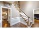 Well-lit foyer showcases hardwood floors, a staircase, and classic neutral wall colors at 110 Amsterdam Dr, Lilburn, GA 30047