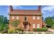 Charming brick two-story home featuring a landscaped front yard and a classic, symmetrical design at 110 Amsterdam Dr, Lilburn, GA 30047