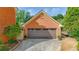 Spacious two car garage with brick facade and ample parking space at 110 Amsterdam Dr, Lilburn, GA 30047