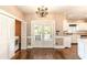 Bright kitchen area with view to backyard and double doors, including laundry closet and white cabinetry at 110 Amsterdam Dr, Lilburn, GA 30047