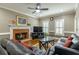 Spacious living room with fireplace, dark sofas, and great natural light at 110 Amsterdam Dr, Lilburn, GA 30047