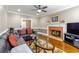 Inviting living room featuring a brick fireplace, dark sofas, and hardwood floors at 110 Amsterdam Dr, Lilburn, GA 30047