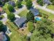 This aerial view shows a backyard oasis with pool, patio, mature trees, and fenced perimeter at 2304 Mitford Ct, Dacula, GA 30019