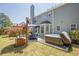 Relaxing backyard featuring a hot tub, patio with umbrella, and well-maintained lawn at 2304 Mitford Ct, Dacula, GA 30019