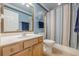 Bathroom with light wood vanity and blue walls with a shower and toilet at 2304 Mitford Ct, Dacula, GA 30019