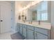 Double sink vanity with modern cabinets in the bathroom featuring sleek fixtures and stylish mirror at 2304 Mitford Ct, Dacula, GA 30019
