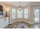 Charming breakfast nook with large windows, tiled floor, and doorway to outside at 2304 Mitford Ct, Dacula, GA 30019