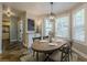 Dining room features modern light fixture, neutral walls, and views of the outdoors at 2304 Mitford Ct, Dacula, GA 30019