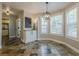 Bright dining room with a bay window, chandelier, and decorative cabinet at 2304 Mitford Ct, Dacula, GA 30019
