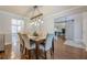 Bright dining room features a modern light fixture and a rustic barn door at 2304 Mitford Ct, Dacula, GA 30019