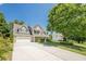 Beautiful two story brick home with a long driveway and a well-manicured lawn on a sunny day at 2304 Mitford Ct, Dacula, GA 30019