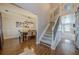 Open foyer featuring a staircase, hardwood floors, and adjacent dining and living areas at 2304 Mitford Ct, Dacula, GA 30019