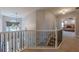 Open hallway with metal banister, hanging light fixture, and views of the main bedroom at 2304 Mitford Ct, Dacula, GA 30019