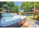 Relaxing hot tub integrated into the backyard's stone landscaping and green lawn at 2304 Mitford Ct, Dacula, GA 30019
