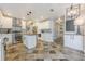 Open kitchen with stone floors, island, stainless appliances, and access to dining area at 2304 Mitford Ct, Dacula, GA 30019