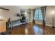 Spacious office with hardwood floors, natural light, and ample workspace for productivity at 2304 Mitford Ct, Dacula, GA 30019