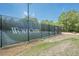 A tennis court with black fence, and the words Wolf Creek printed largely on the fence at 2304 Mitford Ct, Dacula, GA 30019