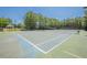 Community tennis courts surrounded by trees and lighting at 2304 Mitford Ct, Dacula, GA 30019