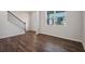 Spacious living room features beautiful hardwood floors, a staircase, and lots of natural light from the large window at 80 Hampton Ter, Dallas, GA 30157