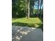 The expansive backyard features lush grass and mature trees at 851 Shore Dr, Lithonia, GA 30058