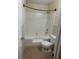 Well-lit bathroom featuring a bathtub and shower combination, and a modern toilet at 851 Shore Dr, Lithonia, GA 30058