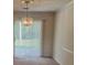 Elegant dining room featuring a chandelier and sliding glass doors leading to the backyard at 851 Shore Dr, Lithonia, GA 30058
