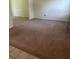 Open-concept living room with neutral carpet flooring and white trim at 851 Shore Dr, Lithonia, GA 30058