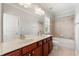 Well-lit bathroom with a double sink vanity, large mirror, and a shower-tub combo, creating a spa-like experience at 4677 Prater Se Way, Smyrna, GA 30080
