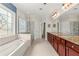Bright bathroom features double vanity, granite counters, soaking tub, and glass enclosed shower at 4677 Prater Se Way, Smyrna, GA 30080