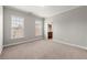 Bright bedroom with windows, neutral carpeting, and access to an en-suite bathroom, providing convenience and comfort at 4677 Prater Se Way, Smyrna, GA 30080