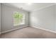 Neutral bedroom with a large window providing ample natural light, offering a serene and calming atmosphere at 4677 Prater Se Way, Smyrna, GA 30080