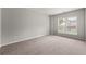 Bright bedroom featuring neutral walls, carpet, and windows with backyard views at 4677 Prater Se Way, Smyrna, GA 30080