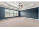Spacious bedroom features a coffered ceiling with fan and plenty of natural light from large windows at 4677 Prater Se Way, Smyrna, GA 30080