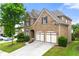 Beautiful brick home featuring a two-car garage and lush green landscaping at 4677 Prater Se Way, Smyrna, GA 30080