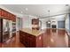 Bright kitchen with a large island, stainless steel appliances, wood cabinetry, and seamless flow to the living room at 4677 Prater Se Way, Smyrna, GA 30080
