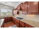Kitchen area showcasing granite countertops, stylish cabinetry, a stainless steel sink, and natural light from the window at 4677 Prater Se Way, Smyrna, GA 30080