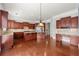 Open kitchen with wood cabinets, an island, and stainless steel appliances, seamlessly connected to a spacious living area at 4677 Prater Se Way, Smyrna, GA 30080