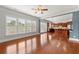 Bright living room with hardwood floors, large windows, and open access to the kitchen at 4677 Prater Se Way, Smyrna, GA 30080