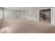 Expansive living room with neutral walls, plush carpet, and staircase access at 4677 Prater Se Way, Smyrna, GA 30080