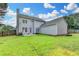 Expansive backyard with lush green grass, surrounded by trees, and a gray house at 4901 Briarleigh Chase Sw, Mableton, GA 30126